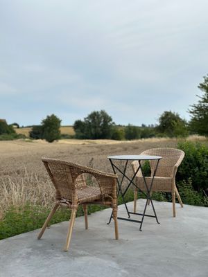 Terrassen utanför växthuset med de öppna fälten