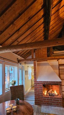 Vy från allrum mot kök där man ser vattnet och skymtar båthuset utanför