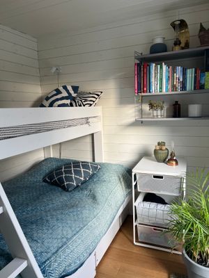 Mysigt litet sovrum med familjesäng i anslutning till kök och allrum.