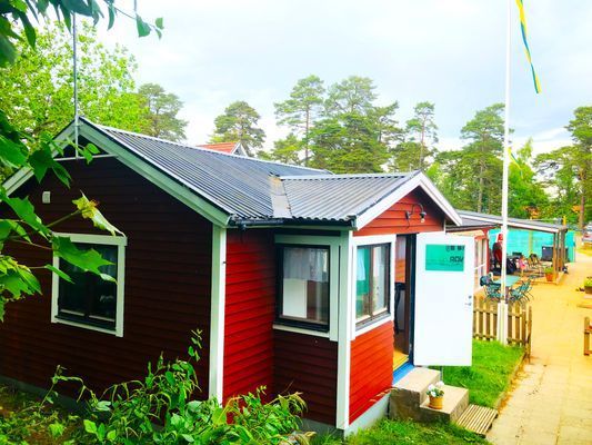 Stugan ligger inne på tennisklubbens område men har ett eget privat läge nere i ena hörnet. Det finns ett staket med grind runt stugan och uteplatsen (15m2) på baksidan är helt insynsskyddad. Det finns ett högt staket mellan tennisbanorna och stugan.