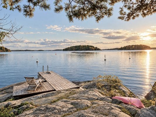 Sjöutsikt från privat brygga med soluppgång