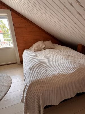 Gästhus 1: Det större sovrummet med dubbelsäng och balkong