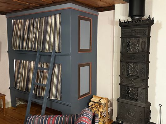 Våningssäng och braskamin i vardagsrummet