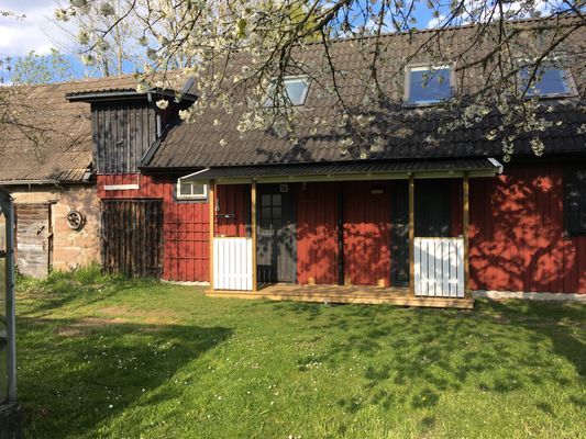 Ingången till vänster leder till WC, dusch och tvättmaskin, samt trappan upp till sovrummet. Dörren till höger leder in till allrummet.