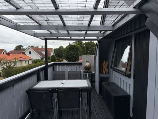 Balkong utrustad med liten grill, utrymme att hänga kläder och flera sittplatser med underbar utsikt